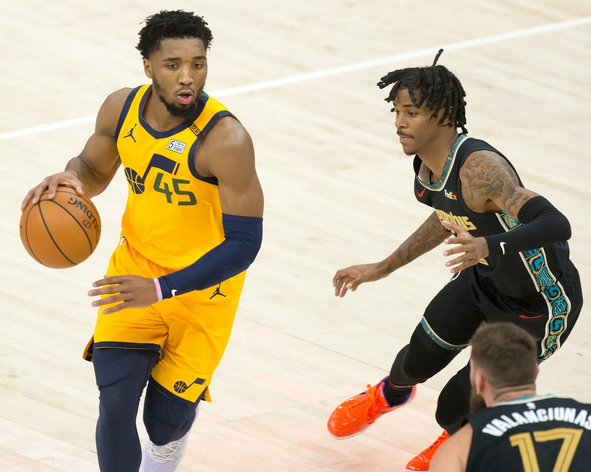 Donovan Mitchell (45) drives into the paint past Ja Morant (12) 